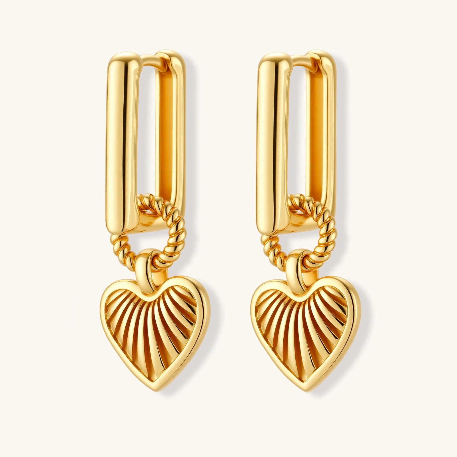 18K gold-plated rectangular huggie hoops with twisted rope ring and ribbed sunray heart charm pendant, on white background.